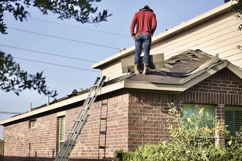 Professional roofer working on a residential roof in Troutman Park